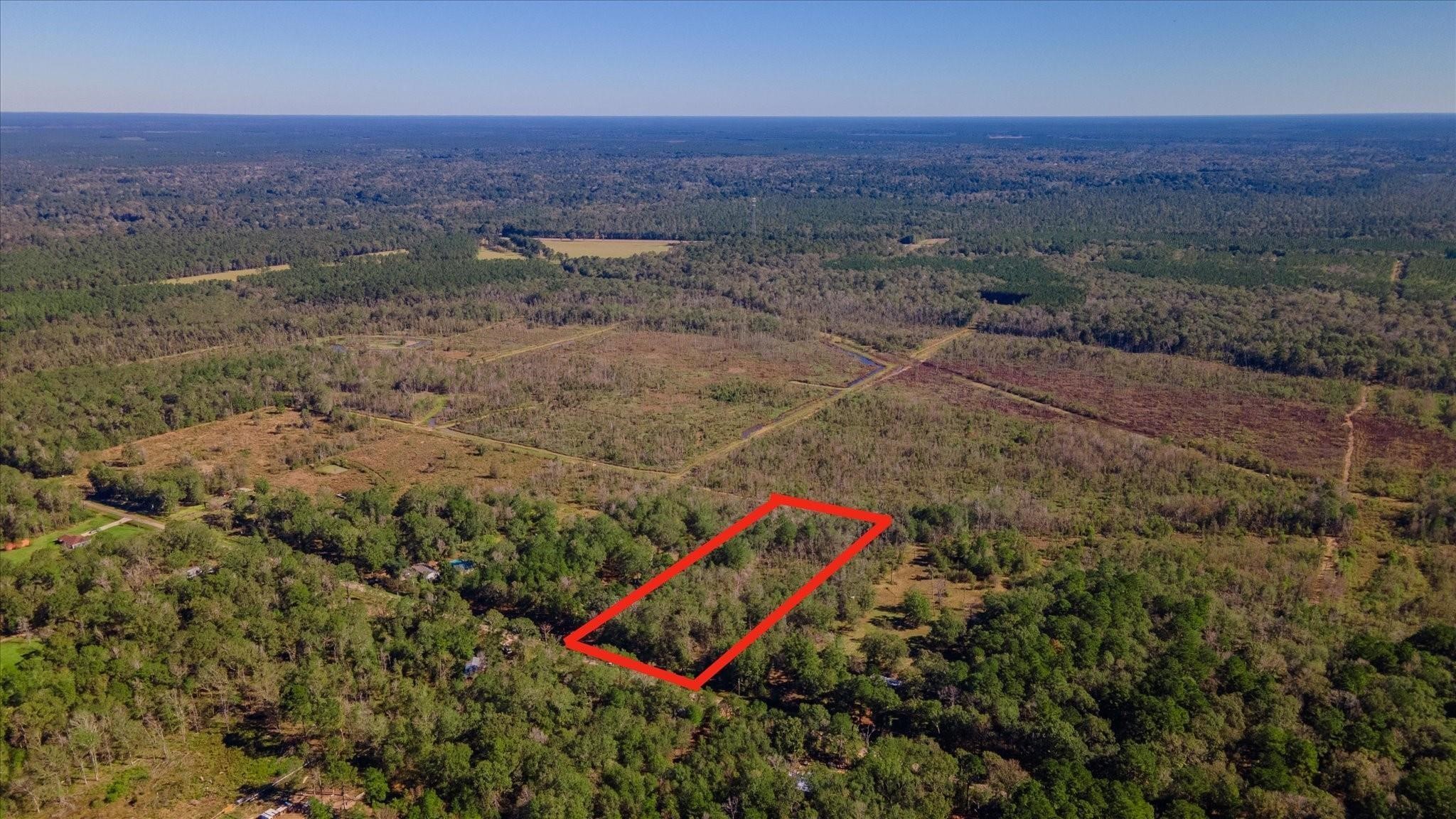 1234 County Road 2145 Cleveland, TX 77327 - Photo 15 of 15 an aerial view of a house with a yard