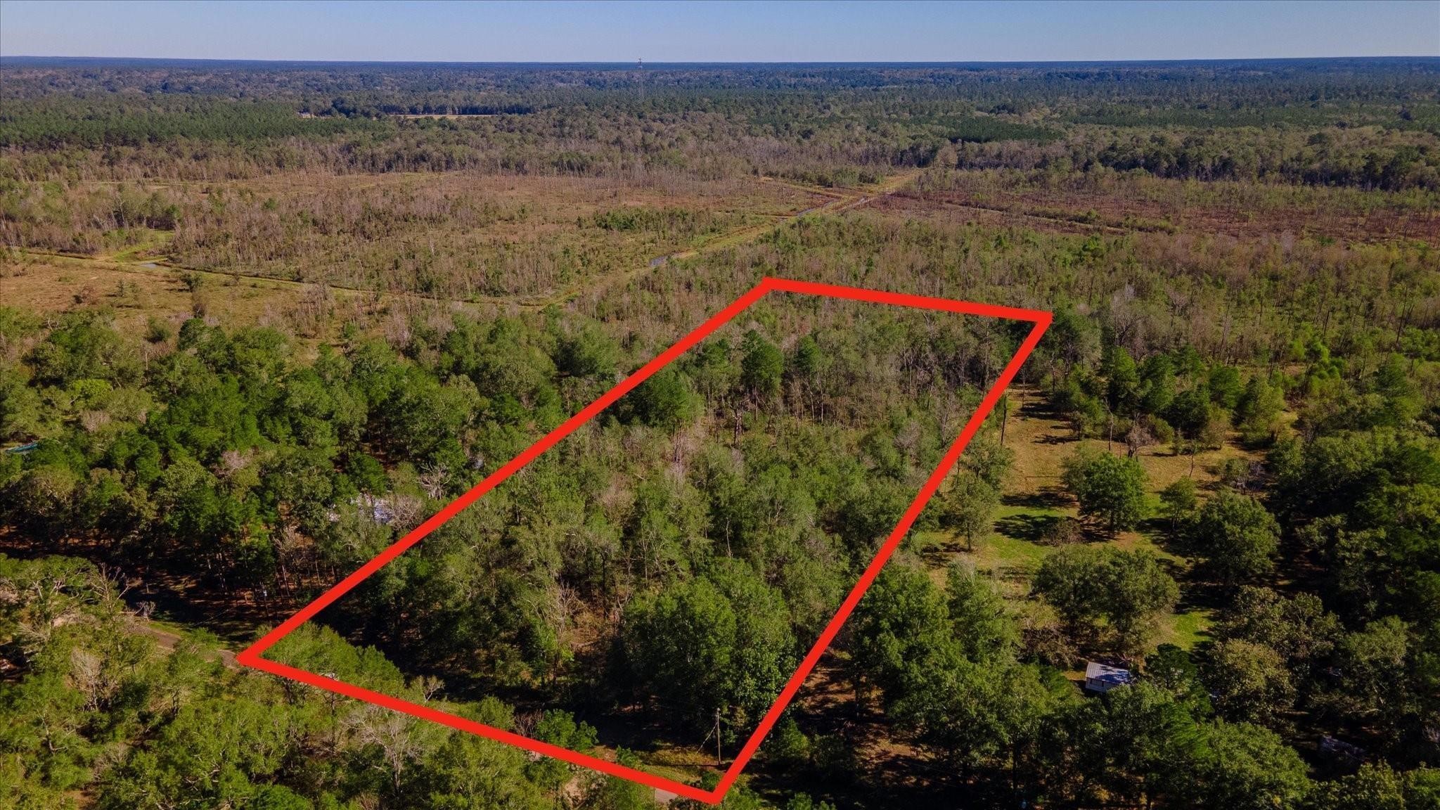 1234 County Road 2145 Cleveland, TX 77327 - Photo 7 of 15 a view of a lush green field