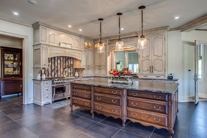 6664 Cross Keys Road College Grove, TN 37046 - Photo 11 of 29 Knock-out kitchen! TOTALLY NEW w/large black porcelain tiled floors with a leather-like look. Huge island, tons of storage, custom cabinets, Wolf dbl. range (gas), leathered granite, SubZero & MORE!