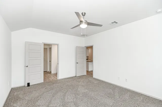 a bathroom with a granite countertop sink a mirror and a bathtub