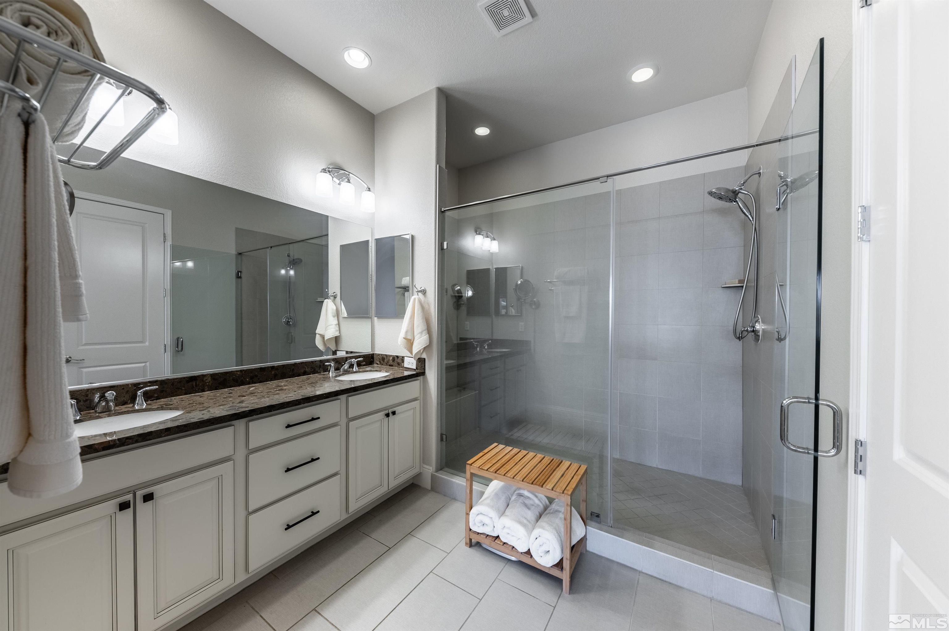 9805 Shadowless Trail Reno, NV 89521 - Photo 13 of 33 a bathroom with a granite countertop sink mirror and shower