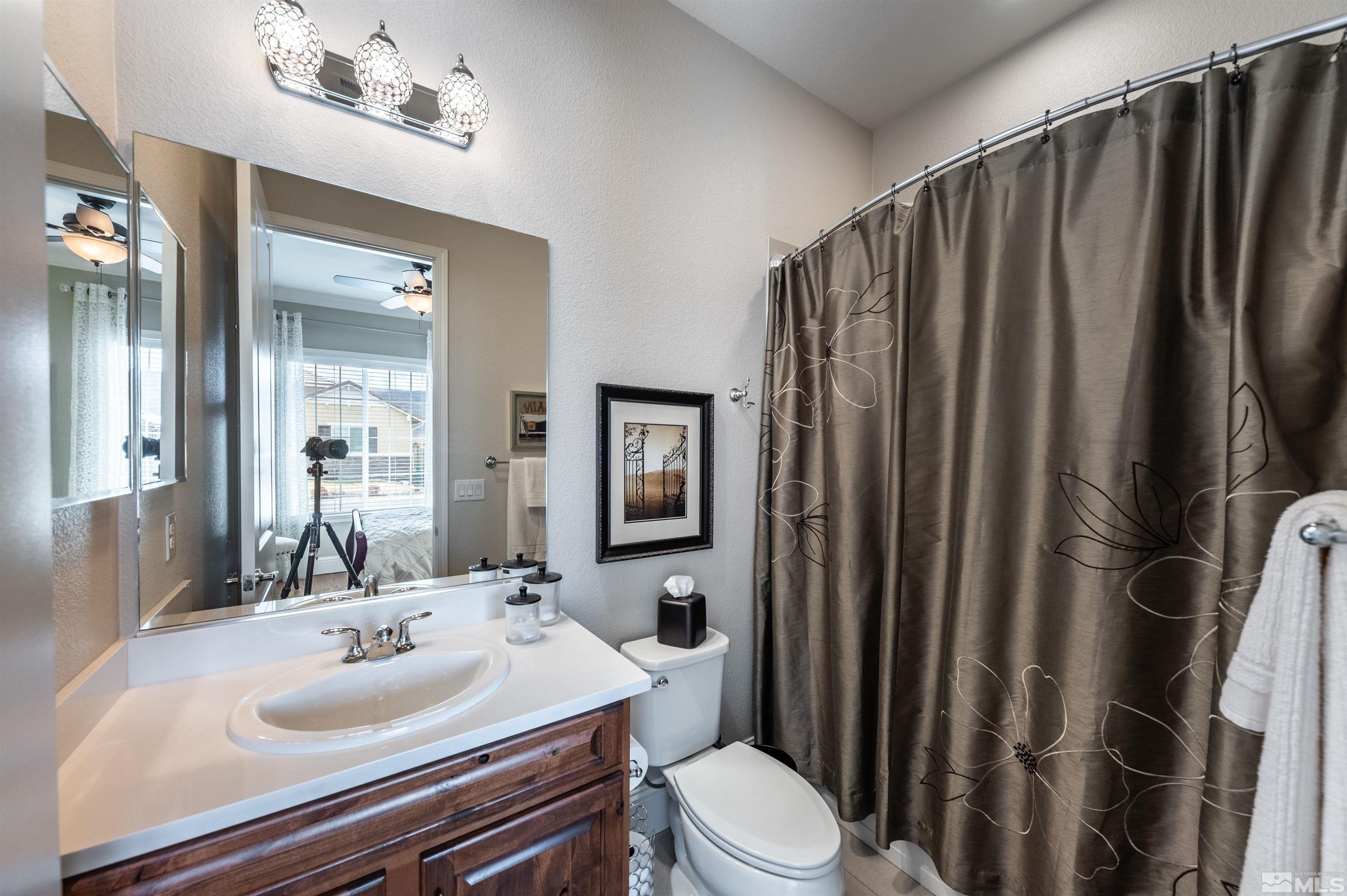 9805 Shadowless Trail Reno, NV 89521 - Photo 17 of 33 a bathroom with a sink a toilet and shower