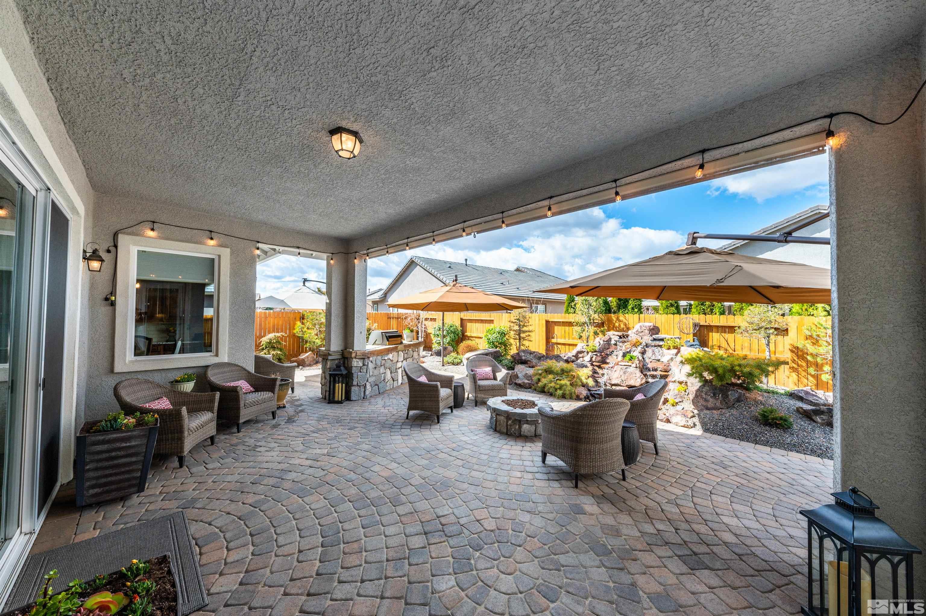 9805 Shadowless Trail Reno, NV 89521 - Photo 19 of 33 a living room with patio furniture and a chandelier
