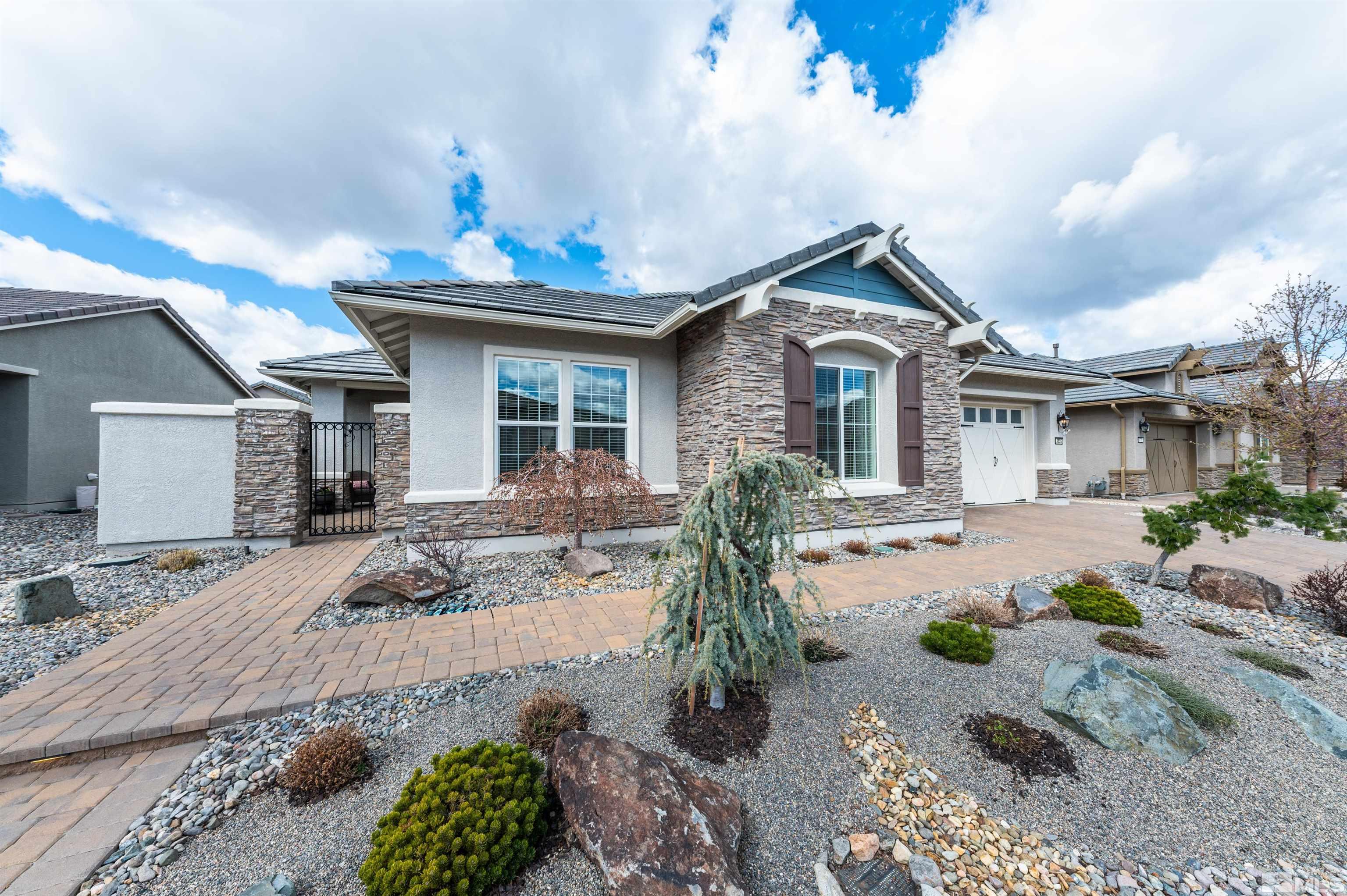 9805 Shadowless Trail Reno, NV 89521 - Photo 3 of 33 a front view of a house with a patio