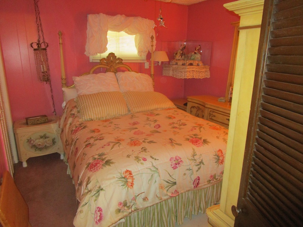 180 Pinetree Road Vowinckel, PA 16260 - Photo 10 of 17 a bed sitting in a bedroom next to a small yard