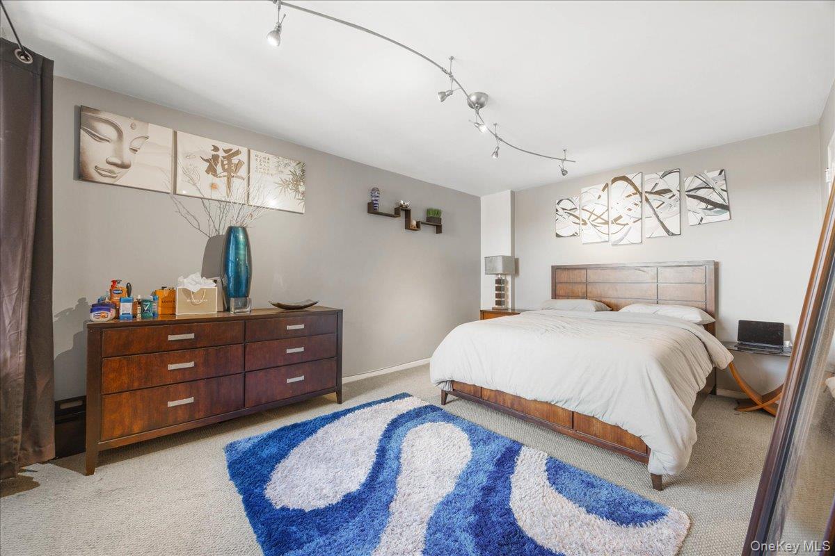 4315 Webster Avenue, Unit 5E Bronx, NY 10470 - Photo 11 of 21 a bedroom with a bed and a mirror on the dresser