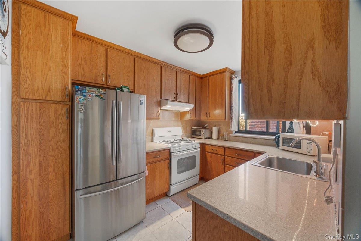 4315 Webster Avenue, Unit 5E Bronx, NY 10470 - Photo 17 of 21 a kitchen with stainless steel appliances granite countertop a refrigerator a sink dishwasher a stove top oven a refrigerator and dishwasher
