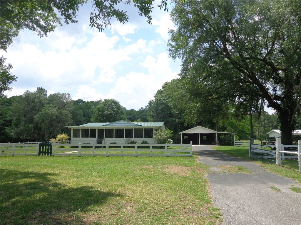 56002 Griffin Road Callahan, FL 32011 - Photo 1 of 10 a front view of a house with a yard table and chairs