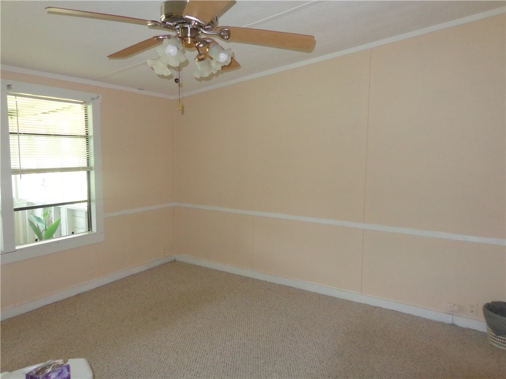 56002 Griffin Road Callahan, FL 32011 - Photo 6 of 10 en empty room with windows and ceiling fan