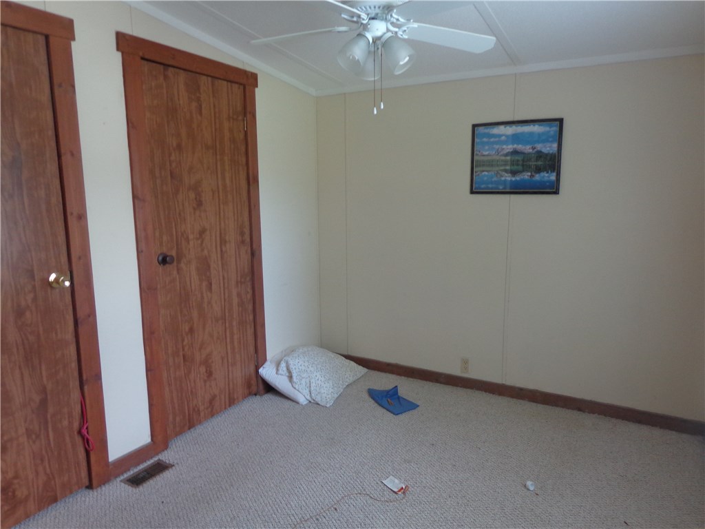 56002 Griffin Road Callahan, FL 32011 - Photo 8 of 10 an empty room with a ceiling fan and a window