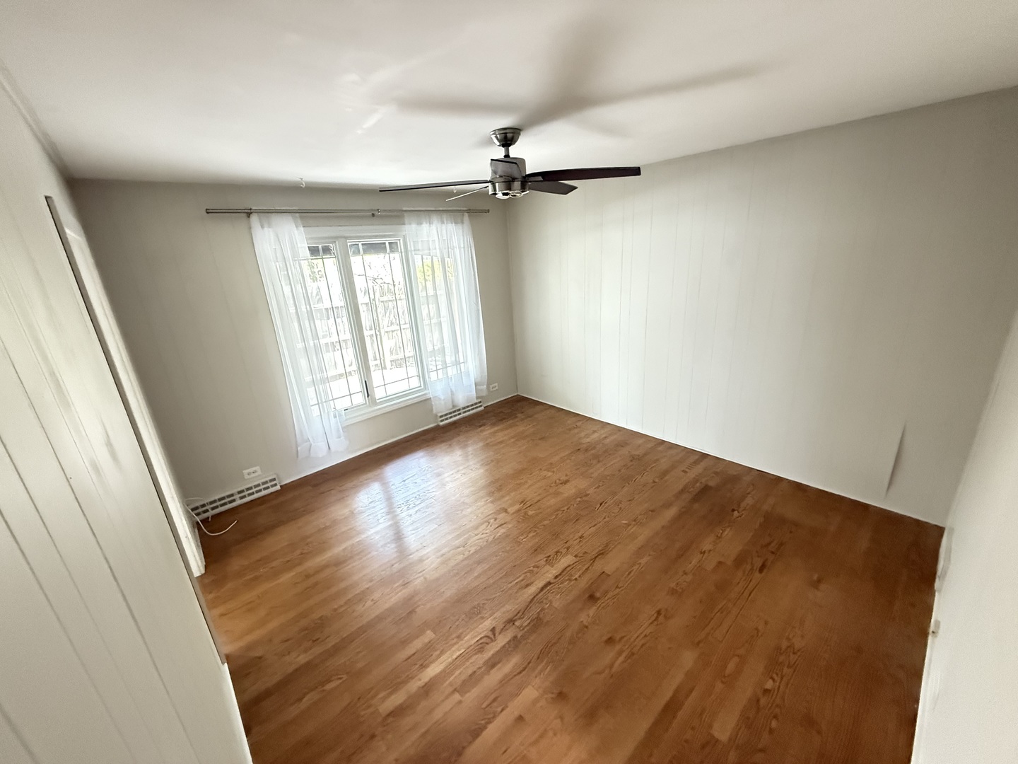 36 Washington Road, Unit 1 Lake Forest, IL 60045 - Photo 7 of 17 wooden floor in an empty room with a window