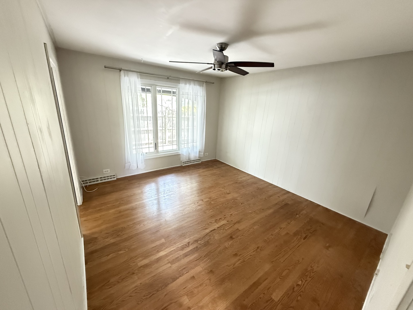 36 Washington Road, Unit 1 Lake Forest, IL 60045 - Photo 8 of 17 an empty room with wooden floor fan and windows