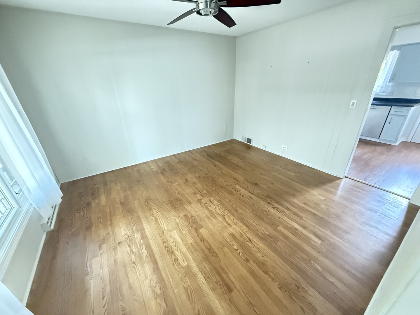 36 Washington Road, Unit 1 Lake Forest, IL 60045 - Photo 9 of 17 a view of a room with wooden floor and a ceiling fan