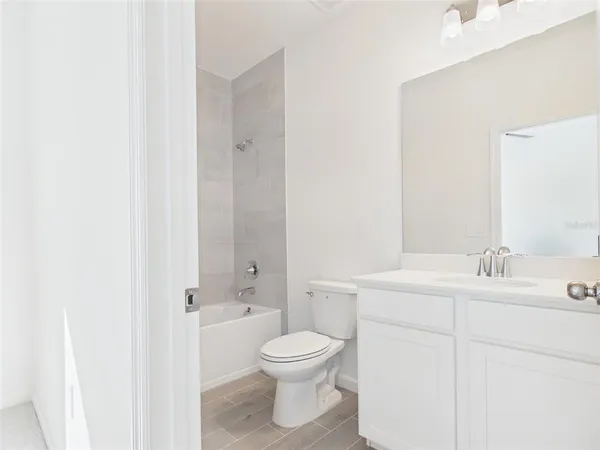a bathroom with a toilet and a bath tub