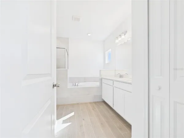 a white toilet sitting next to a white wall