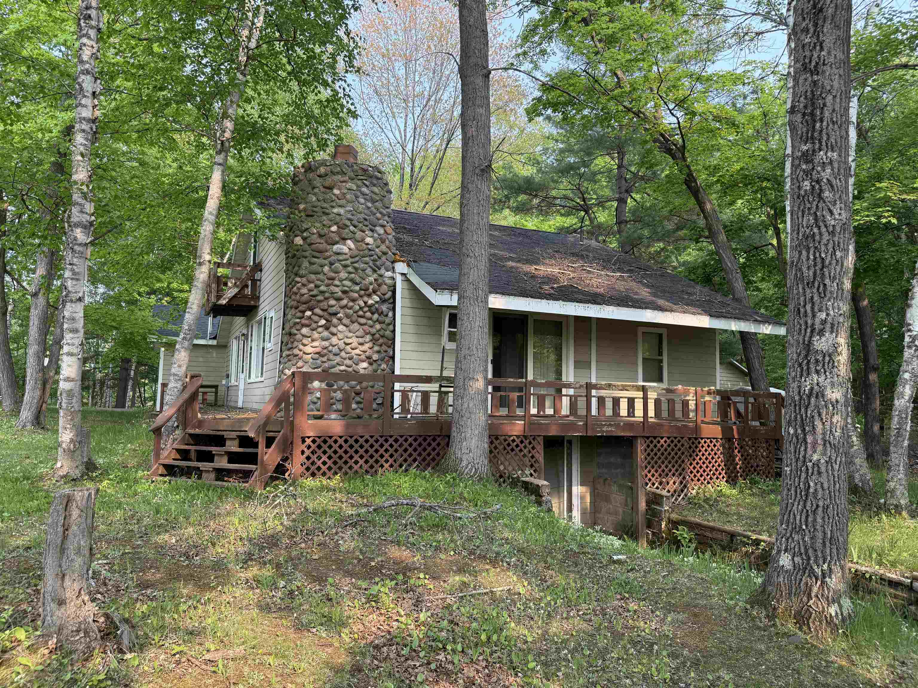 View of front of house with a chimney and a deck
