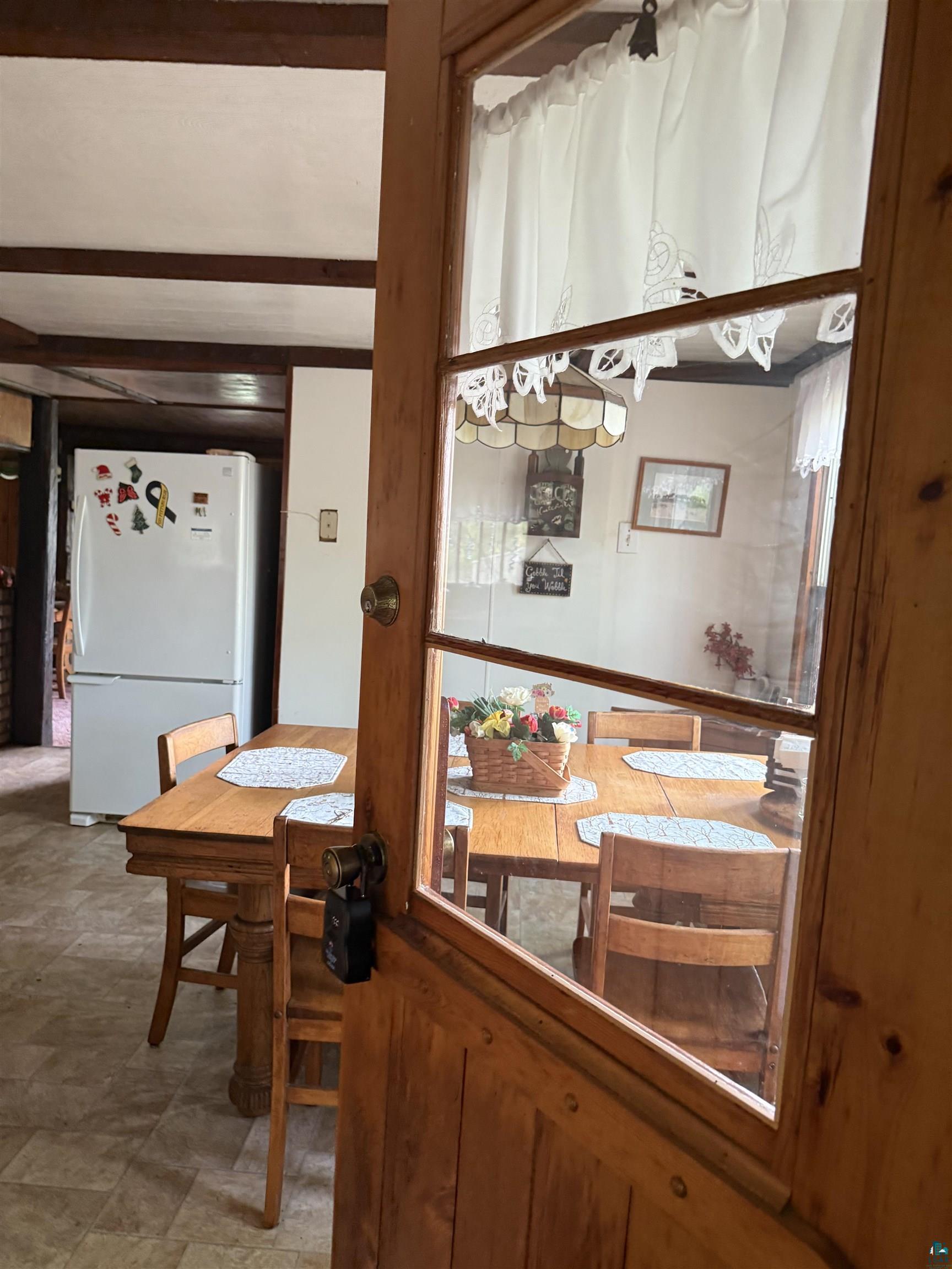 69175 East Long Lake Road Iron River, WI 54847 - Photo 12 of 47 Dining space featuring beamed ceiling