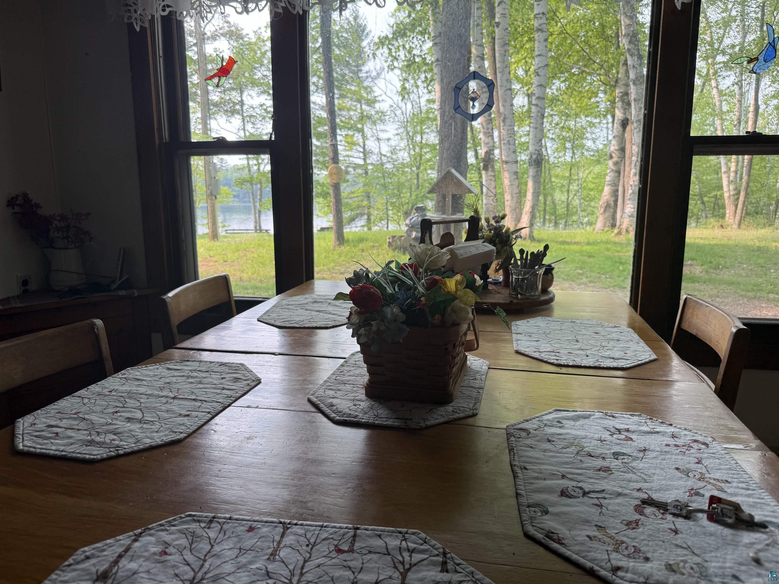 69175 East Long Lake Road Iron River, WI 54847 - Photo 9 of 47 Dining area featuring plenty of natural light and hardwood / wood-style flooring