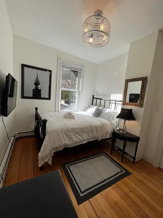 a bedroom with bed and a window