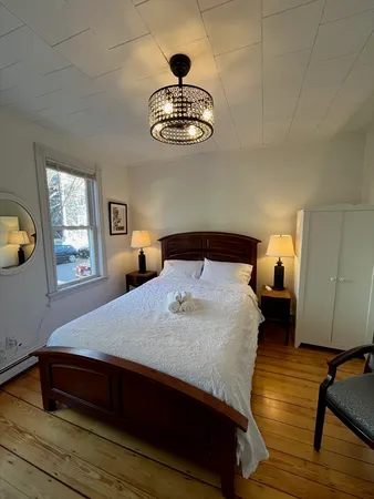 a bedroom with a bed and window