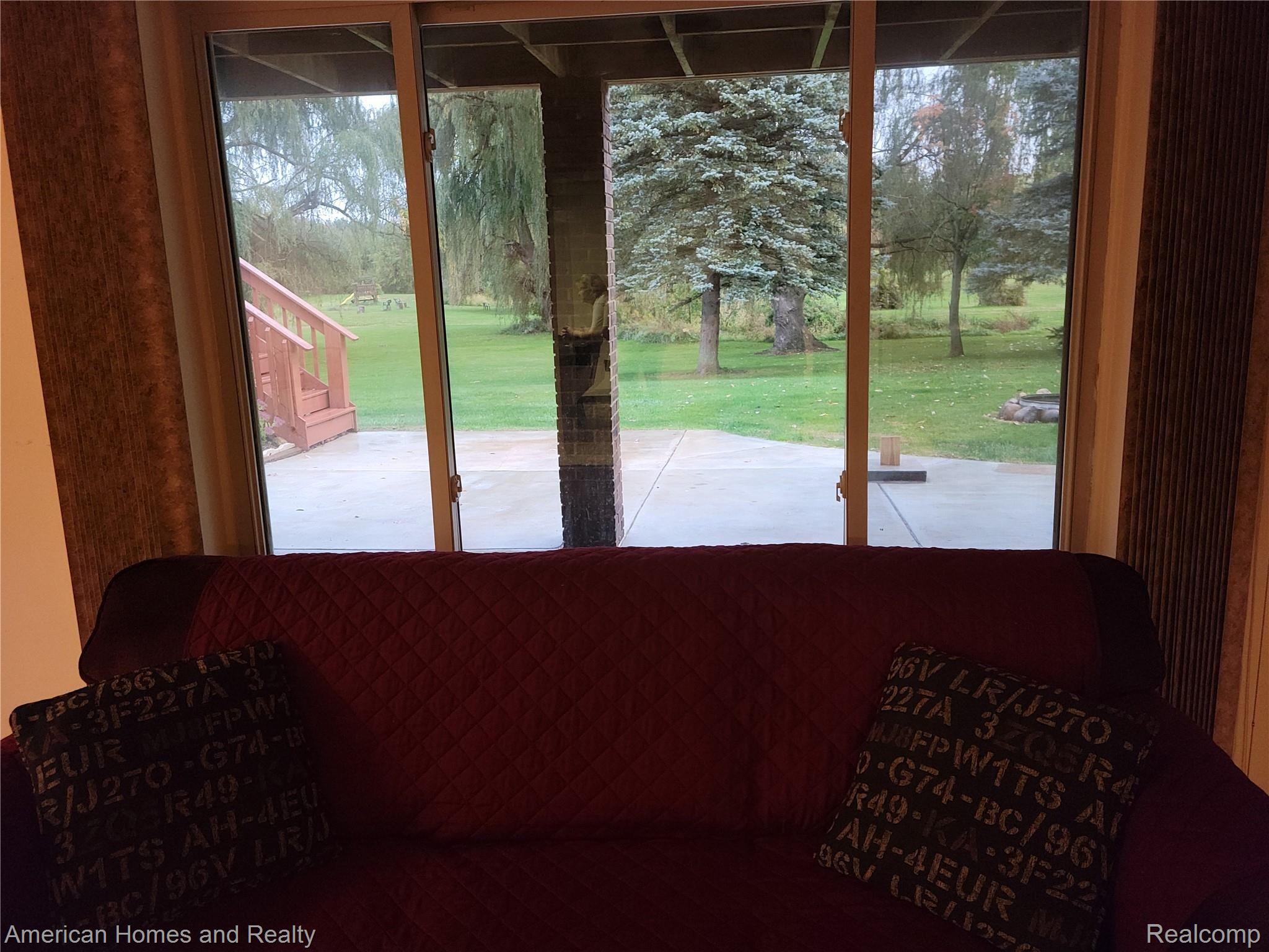 6530 Armstrong Road Imlay City, MI 48444 - Photo 32 of 59 View to backyard from basement dining nook with walkout doorway leading to back patio