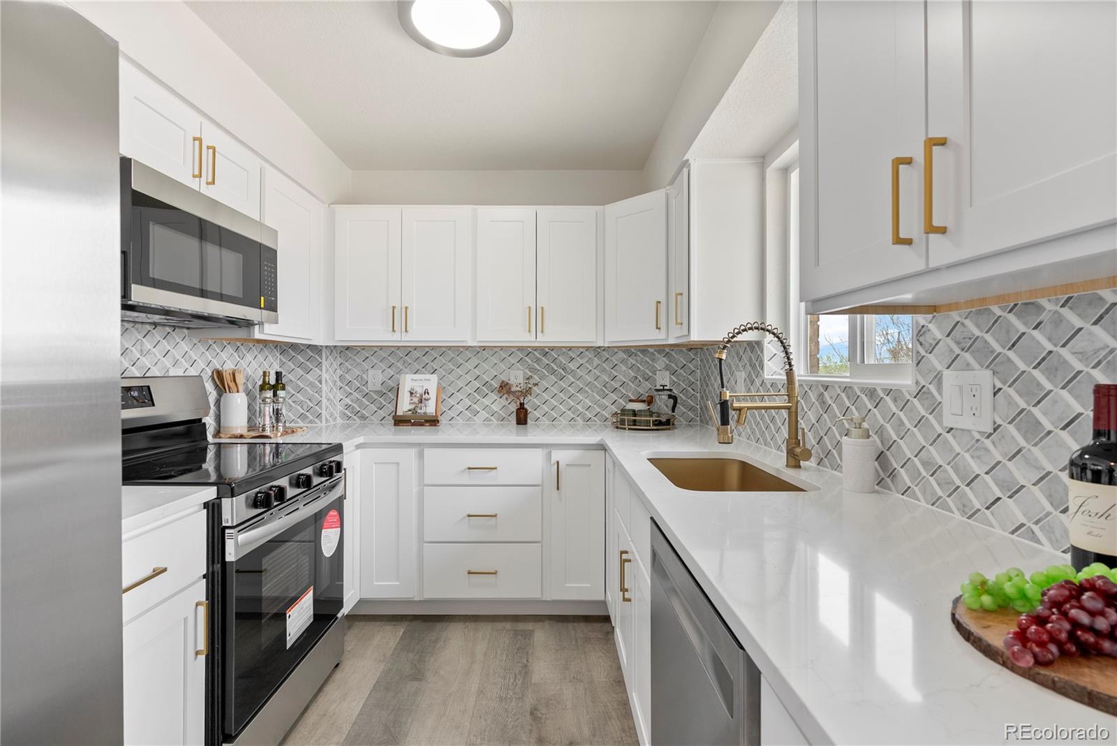 7961 Granada Road Denver, CO 80221 - Photo 12 of 31 a kitchen with stainless steel appliances granite countertop a sink stove and cabinets