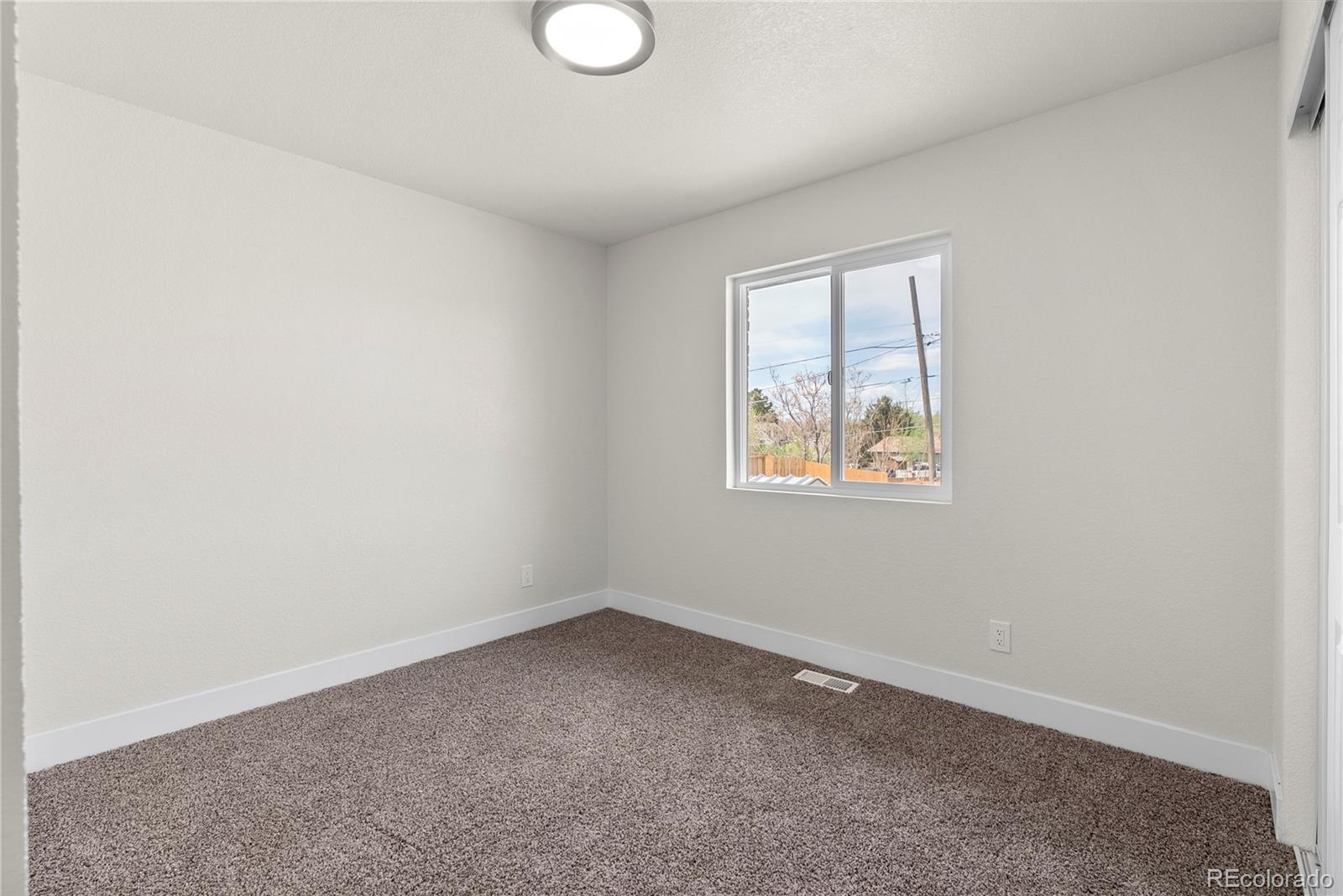 7961 Granada Road Denver, CO 80221 - Photo 14 of 31 an empty room with a window