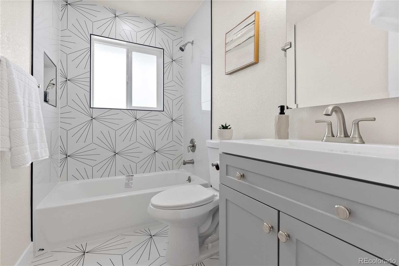 7961 Granada Road Denver, CO 80221 - Photo 17 of 31 a bathroom with a sink a toilet and bathtub