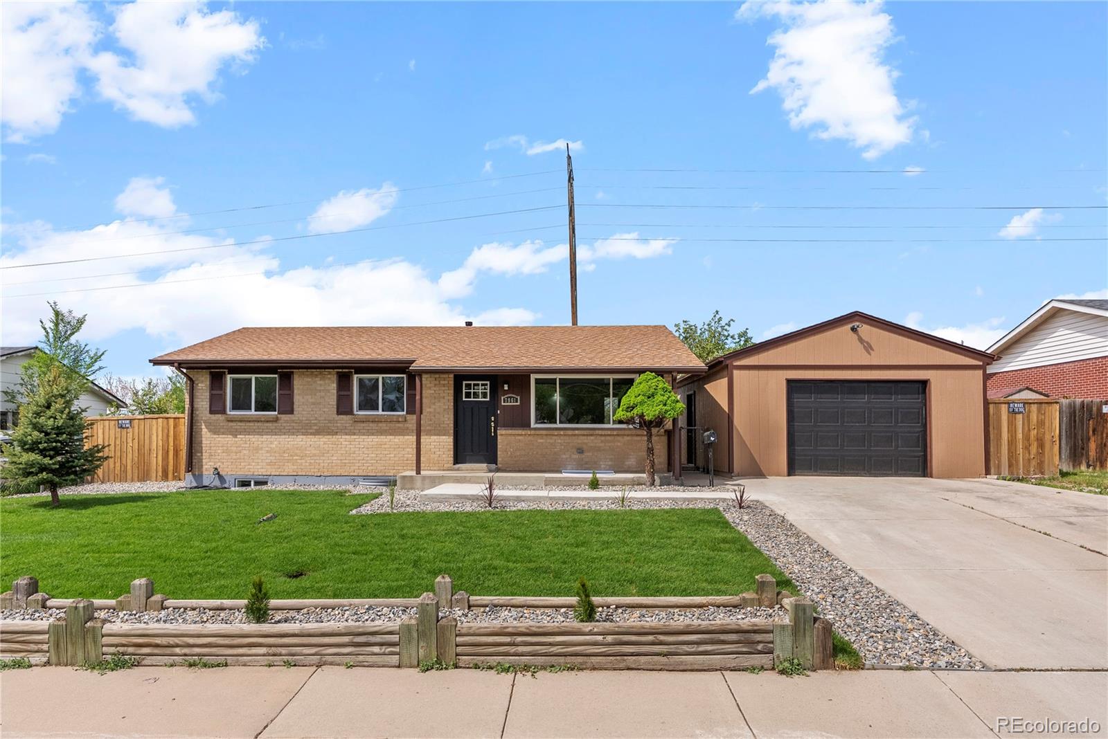 7961 Granada Road Denver, CO 80221 - Photo 2 of 31 a front view of a house with a yard