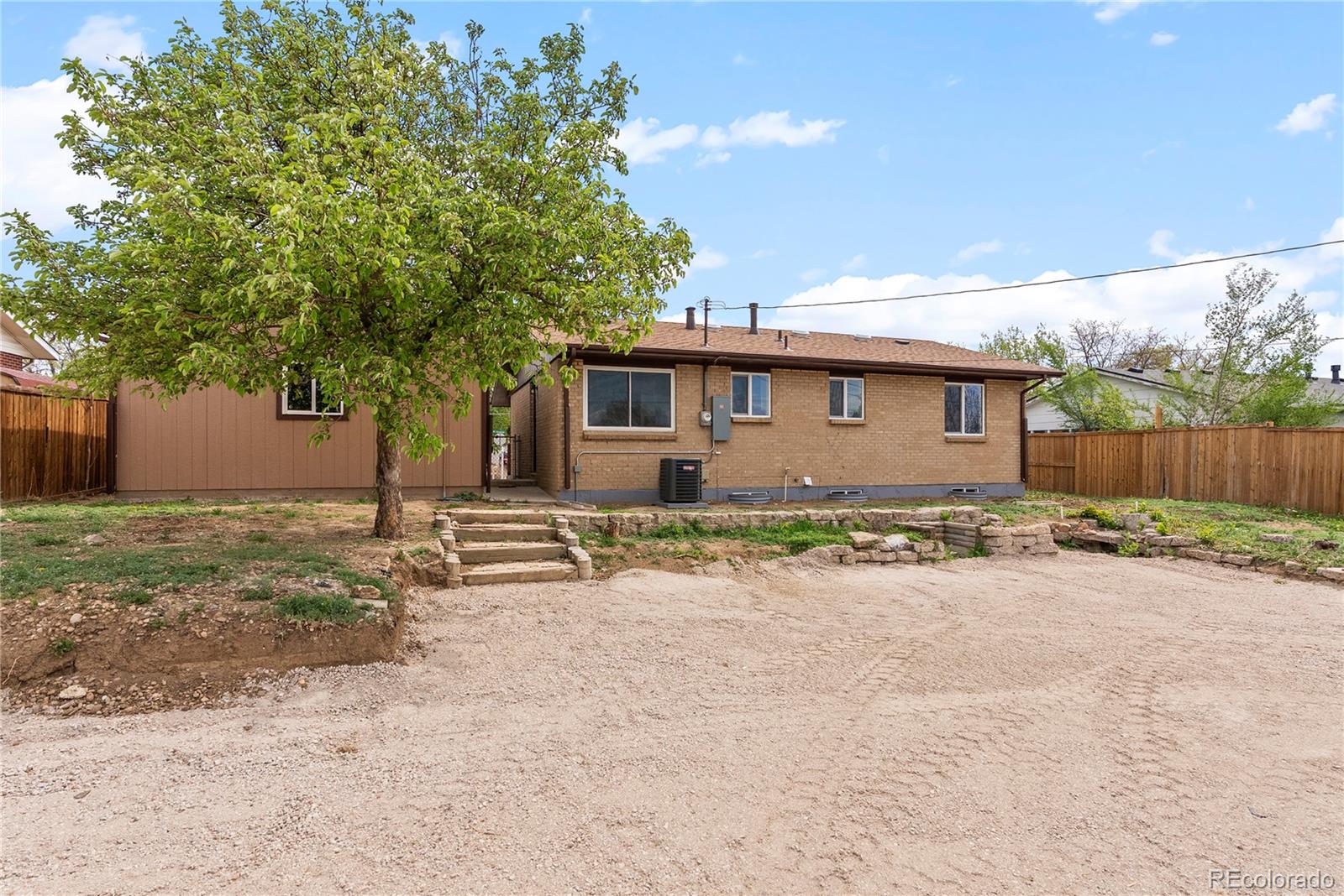 7961 Granada Road Denver, CO 80221 - Photo 25 of 31 a front view of house with yard and trees around