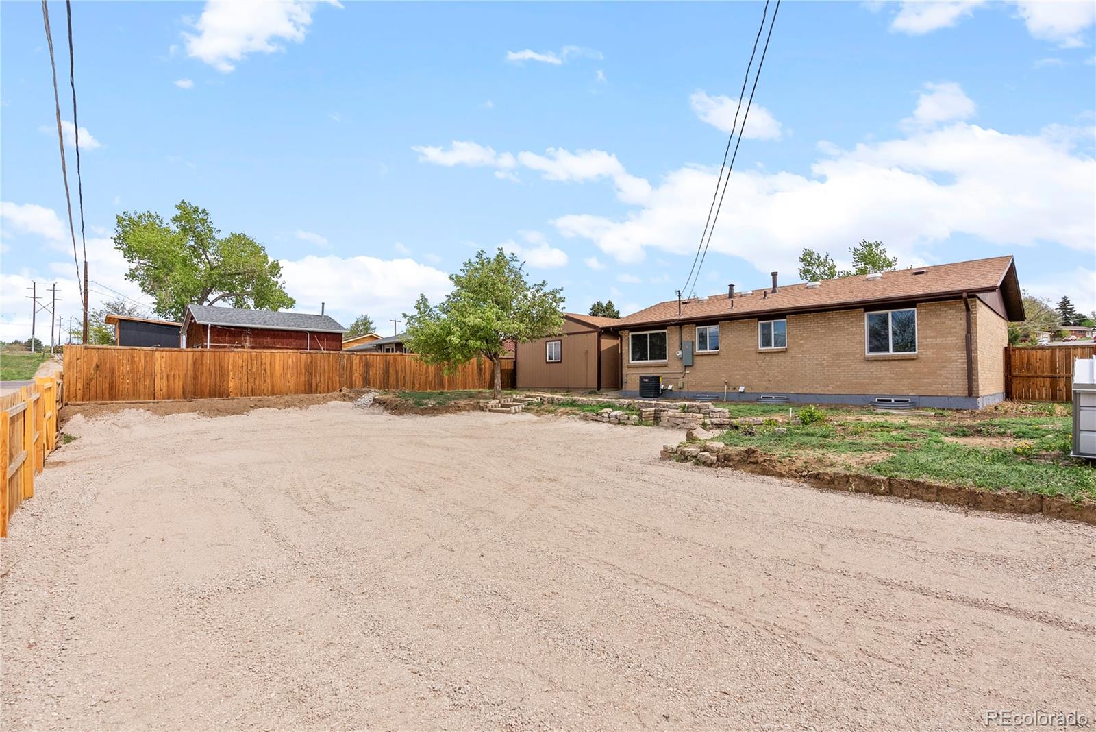7961 Granada Road Denver, CO 80221 - Photo 26 of 31 a front view of a house with a yard and trees