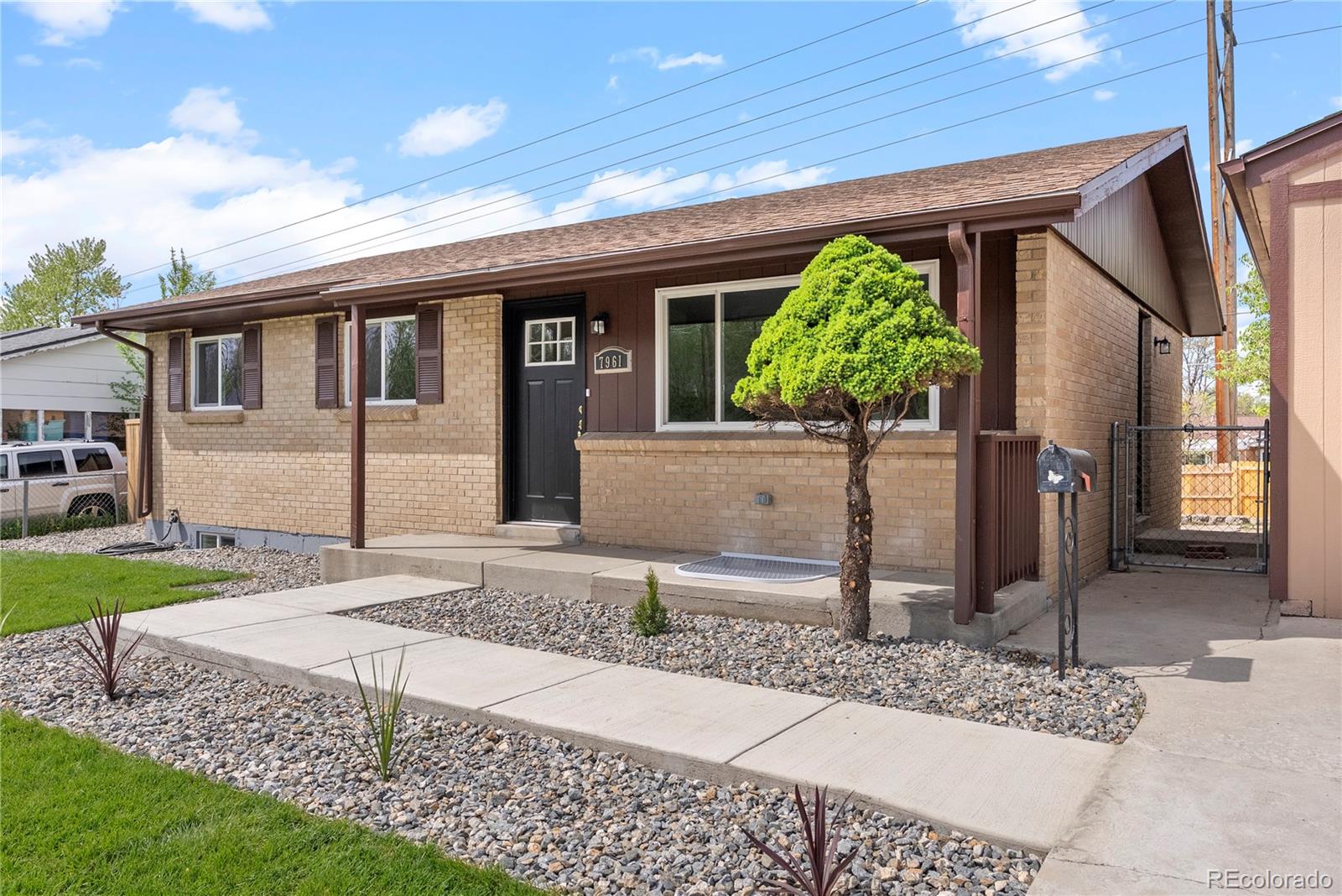 7961 Granada Road Denver, CO 80221 - Photo 4 of 31 a front view of a house with garden