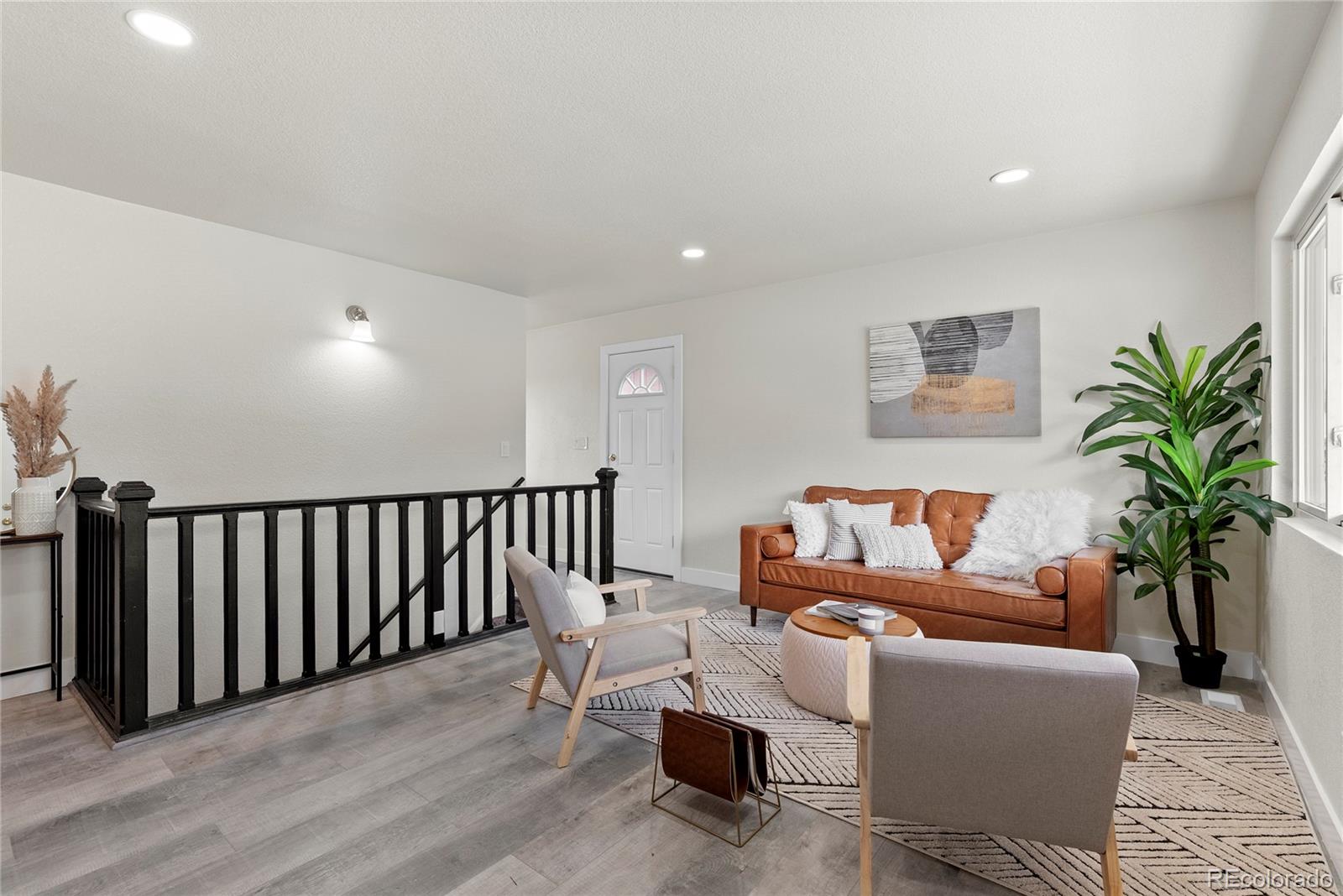 7961 Granada Road Denver, CO 80221 - Photo 6 of 31 a living room with furniture a potted plant and a table