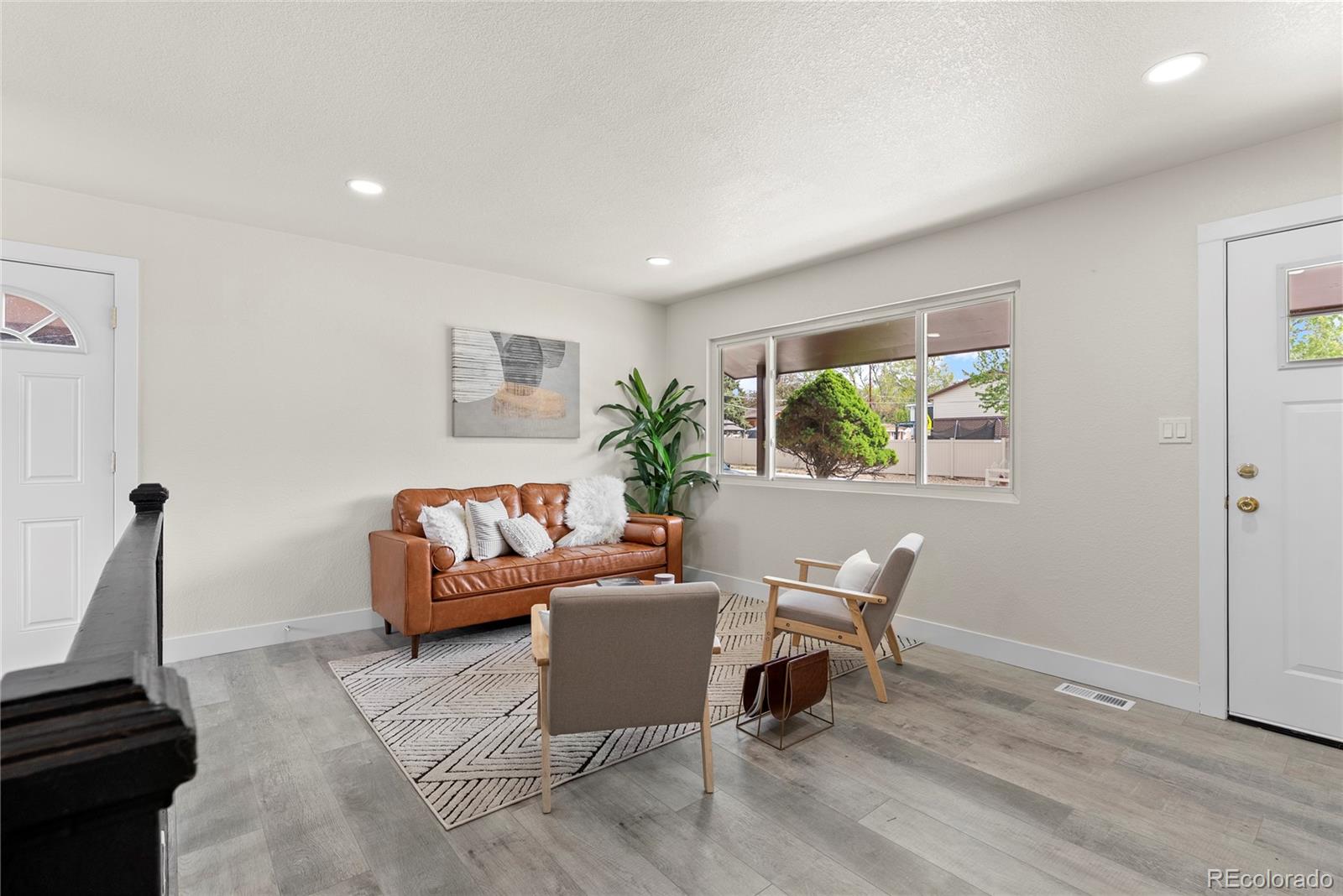 7961 Granada Road Denver, CO 80221 - Photo 7 of 31 a living room with furniture and a window