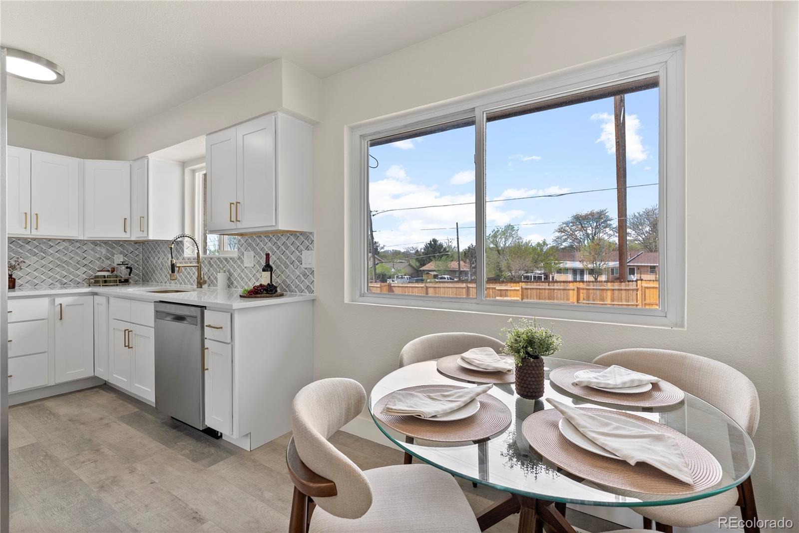 7961 Granada Road Denver, CO 80221 - Photo 9 of 31 a kitchen with a white table and chairs in it