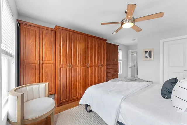 a bedroom with a bed and a chandelier