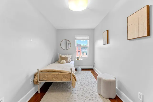 a bedroom with bed and window