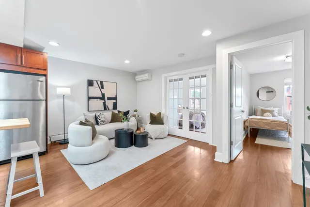 a living room with furniture and a wooden floor