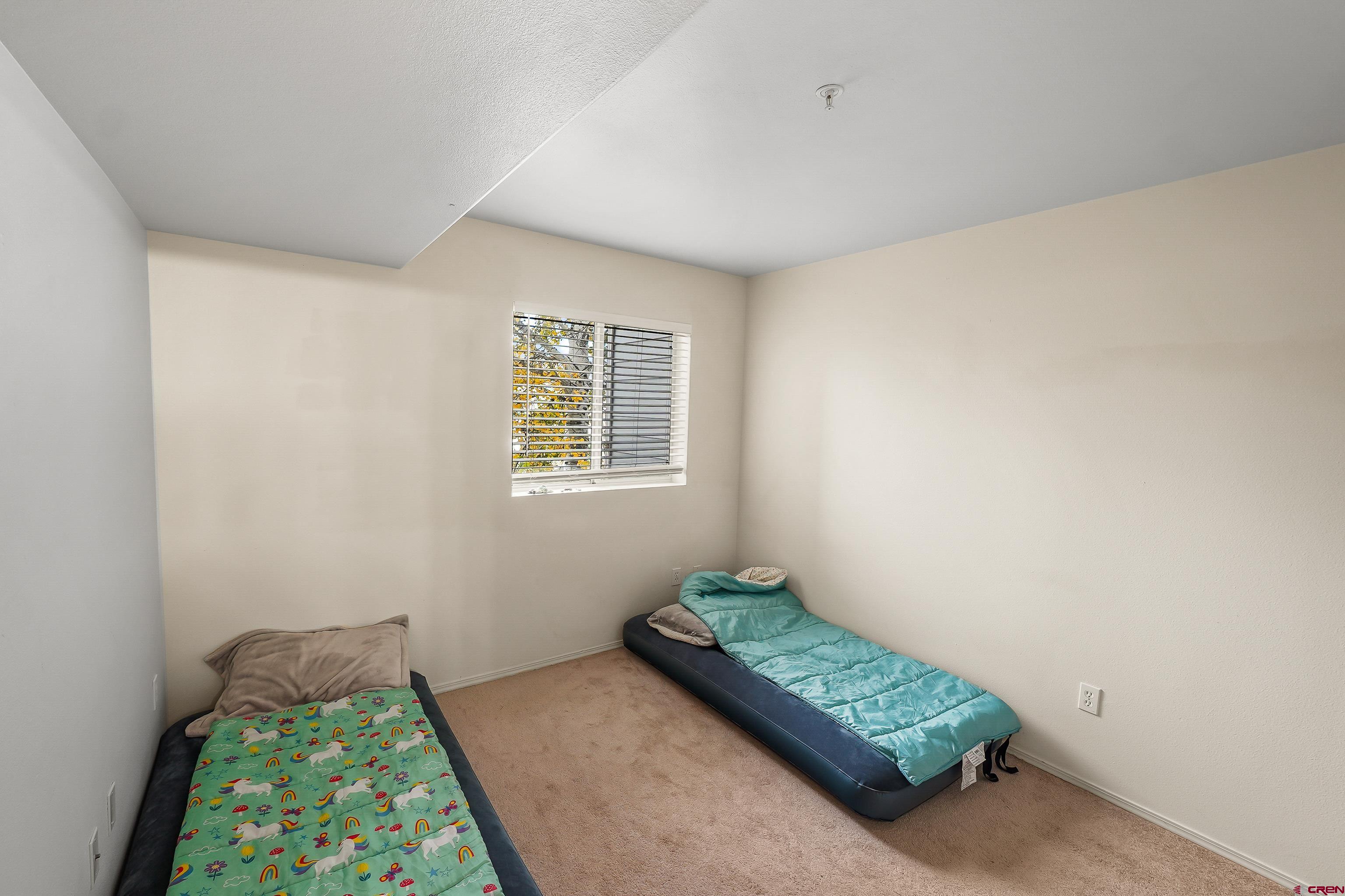 1100 Goeglein Gulch Road, Unit 155 Durango, CO 81301 - Photo 13 of 15 a bedroom with a bed and a window