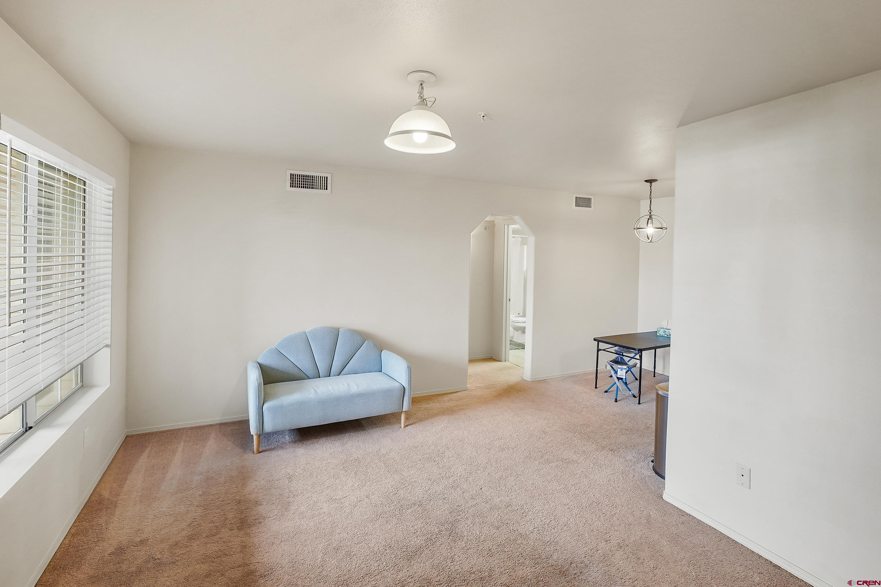 1100 Goeglein Gulch Road, Unit 155 Durango, CO 81301 - Photo 4 of 15 a living room with furniture and a flat screen tv