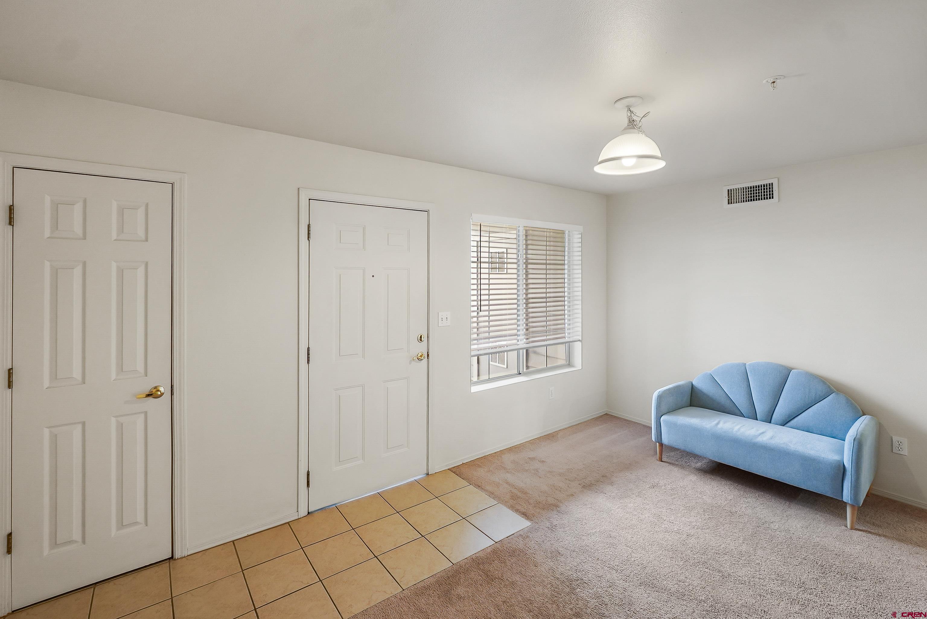 1100 Goeglein Gulch Road, Unit 155 Durango, CO 81301 - Photo 5 of 15 a spacious bedroom with a bed and a couch