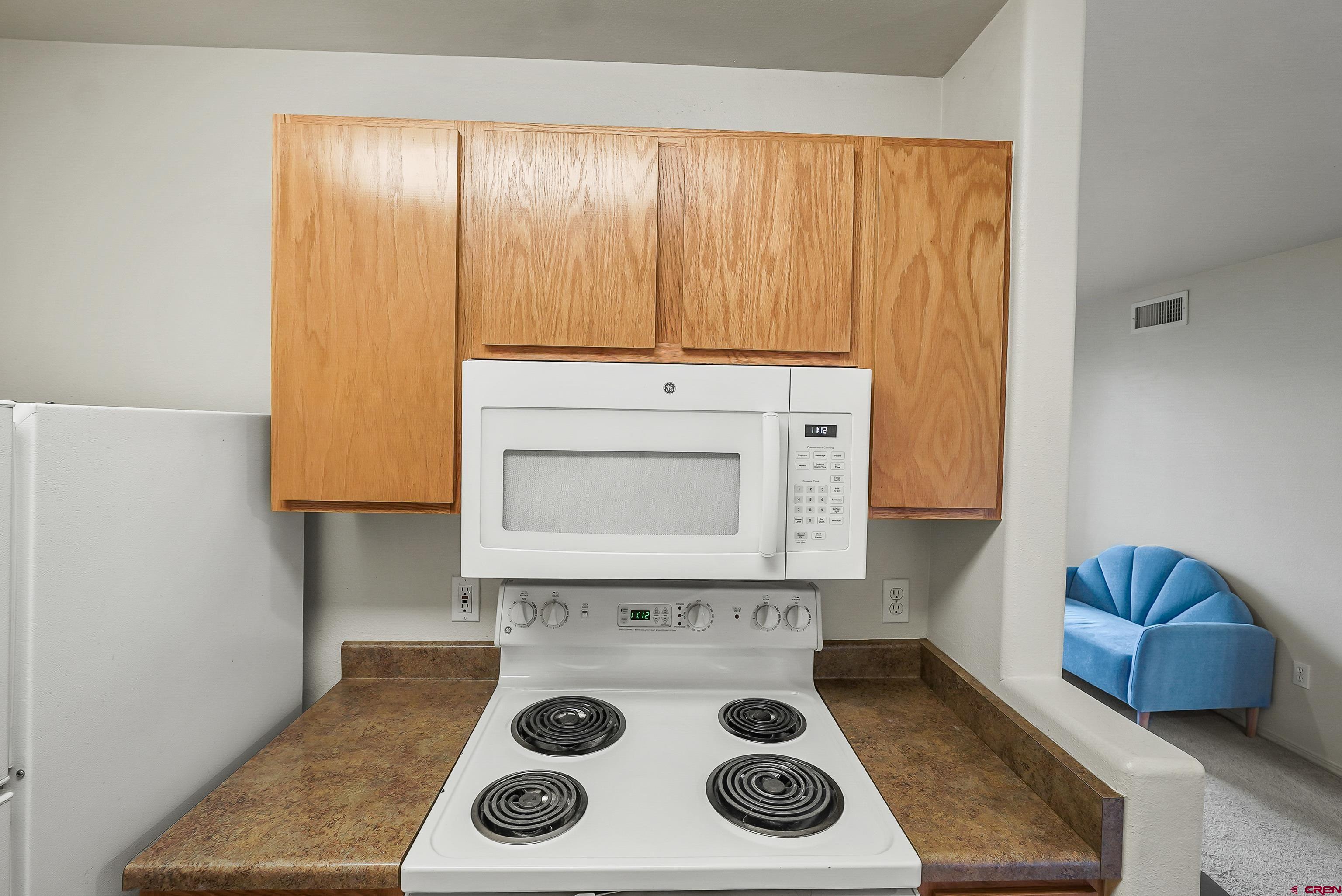 1100 Goeglein Gulch Road, Unit 155 Durango, CO 81301 - Photo 9 of 15 a kitchen with a stove and a microwave