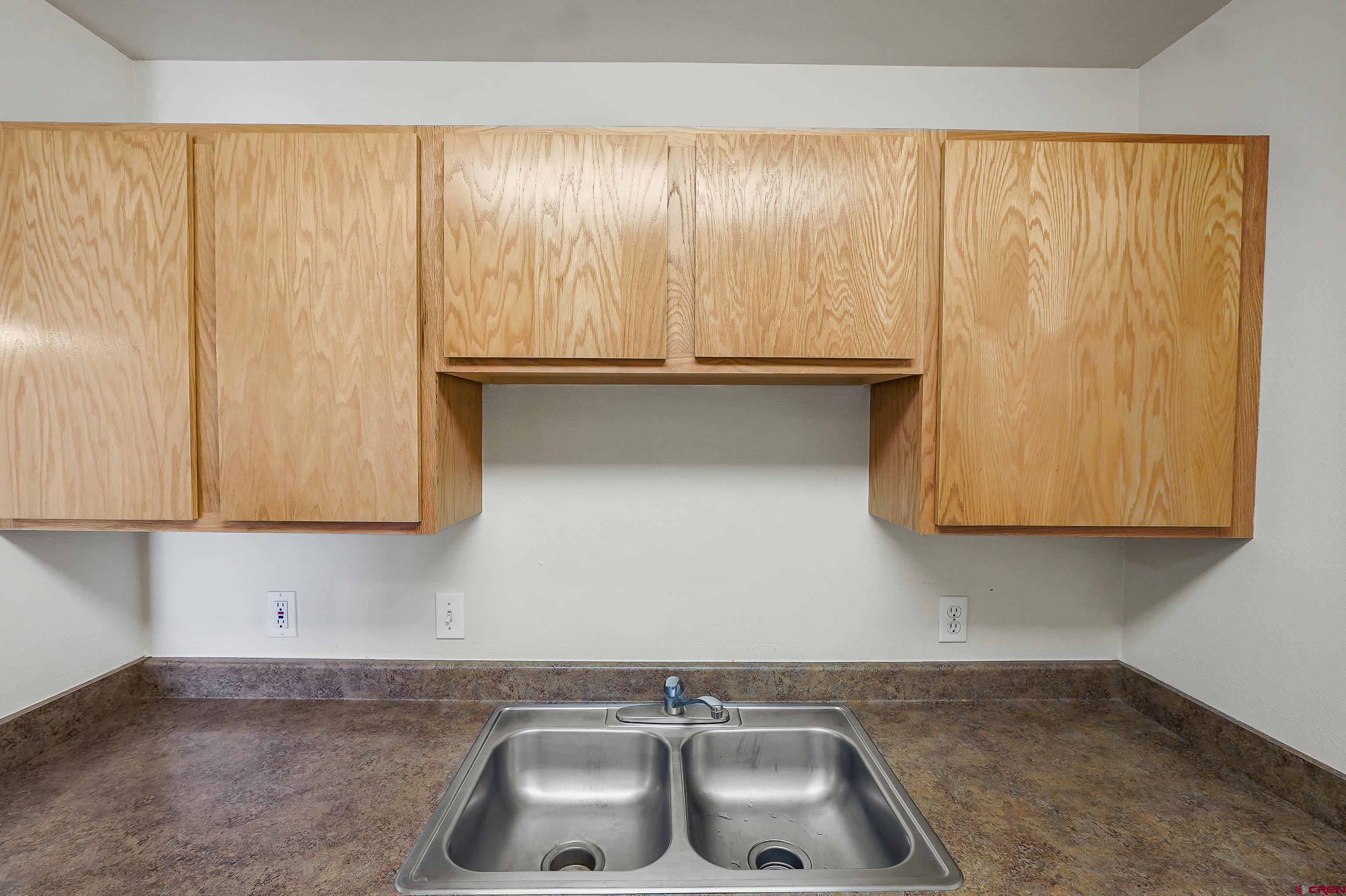 1100 Goeglein Gulch Road, Unit 155 Durango, CO 81301 - Photo 10 of 15 a kitchen with a sink and cabinets
