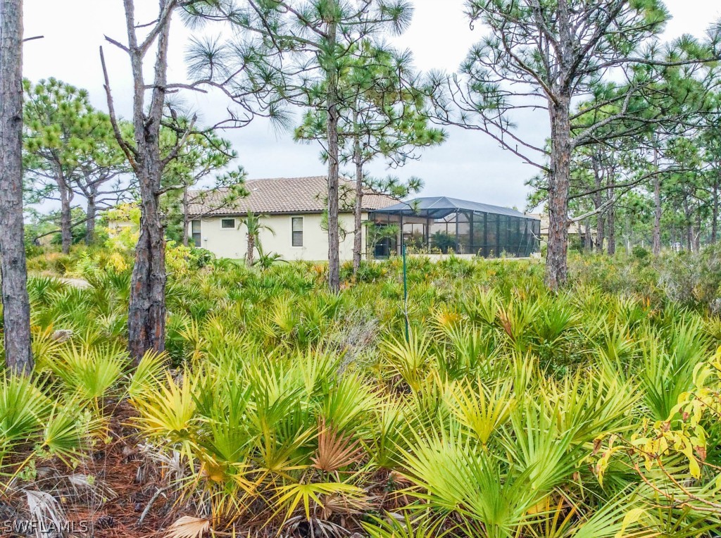 6017 Calusa Rdg Trail Bokeelia, FL 33922 - Photo 13 of 24 a front view of a house with a garden