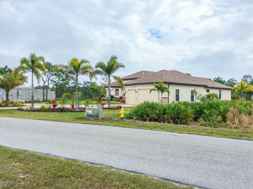 6017 Calusa Rdg Trail Bokeelia, FL 33922 - Photo 20 of 24 a view of a house with a big yard and large trees