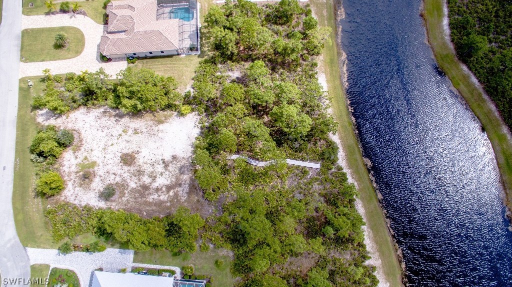 6017 Calusa Rdg Trail Bokeelia, FL 33922 - Photo 4 of 24 a backyard of a house with a yard and garden