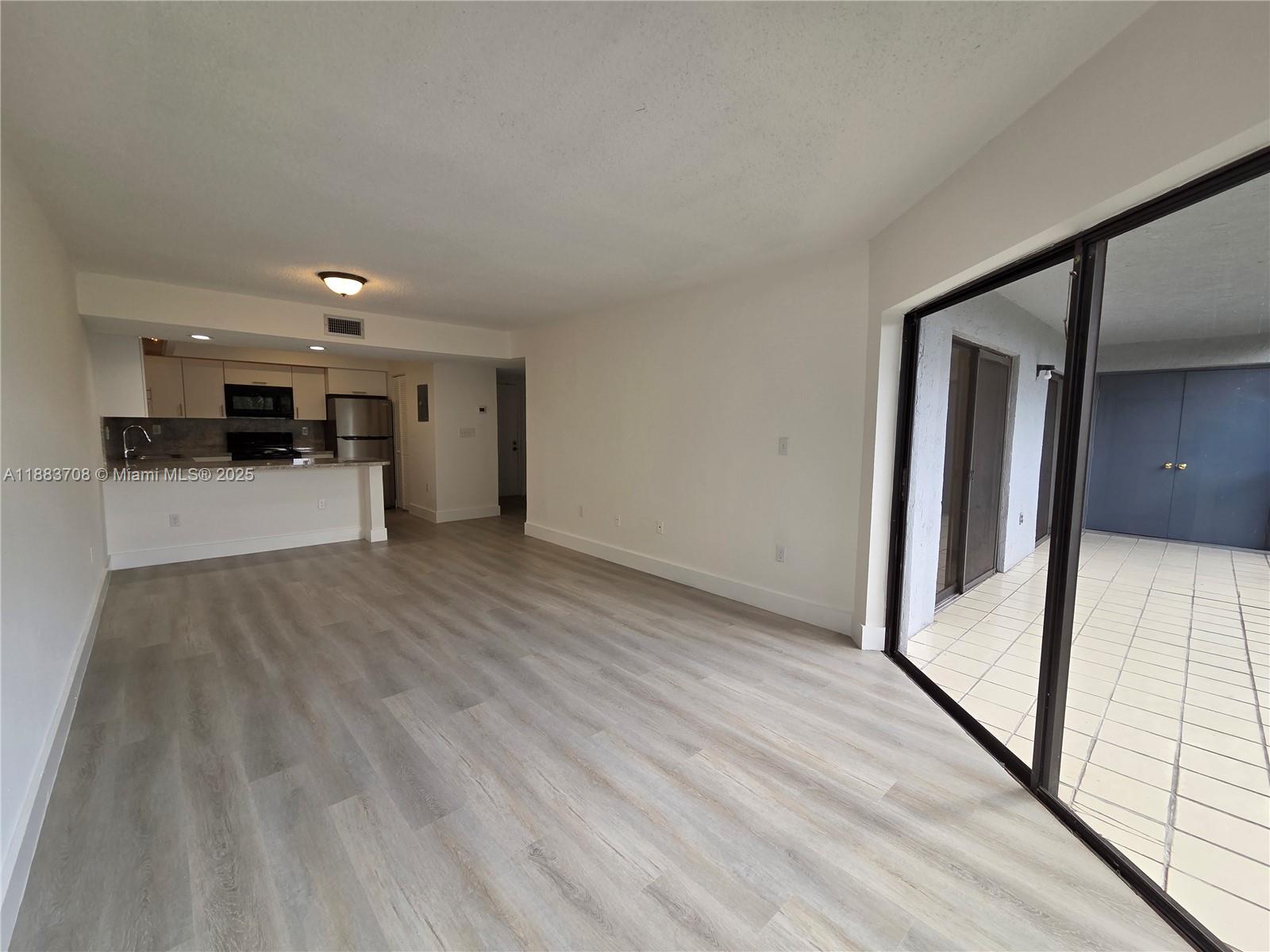 8888 Southwest 131st Court, Unit 308 Miami, FL 33186 - Photo 12 of 25 a view of a hallway with wooden floor and staircase