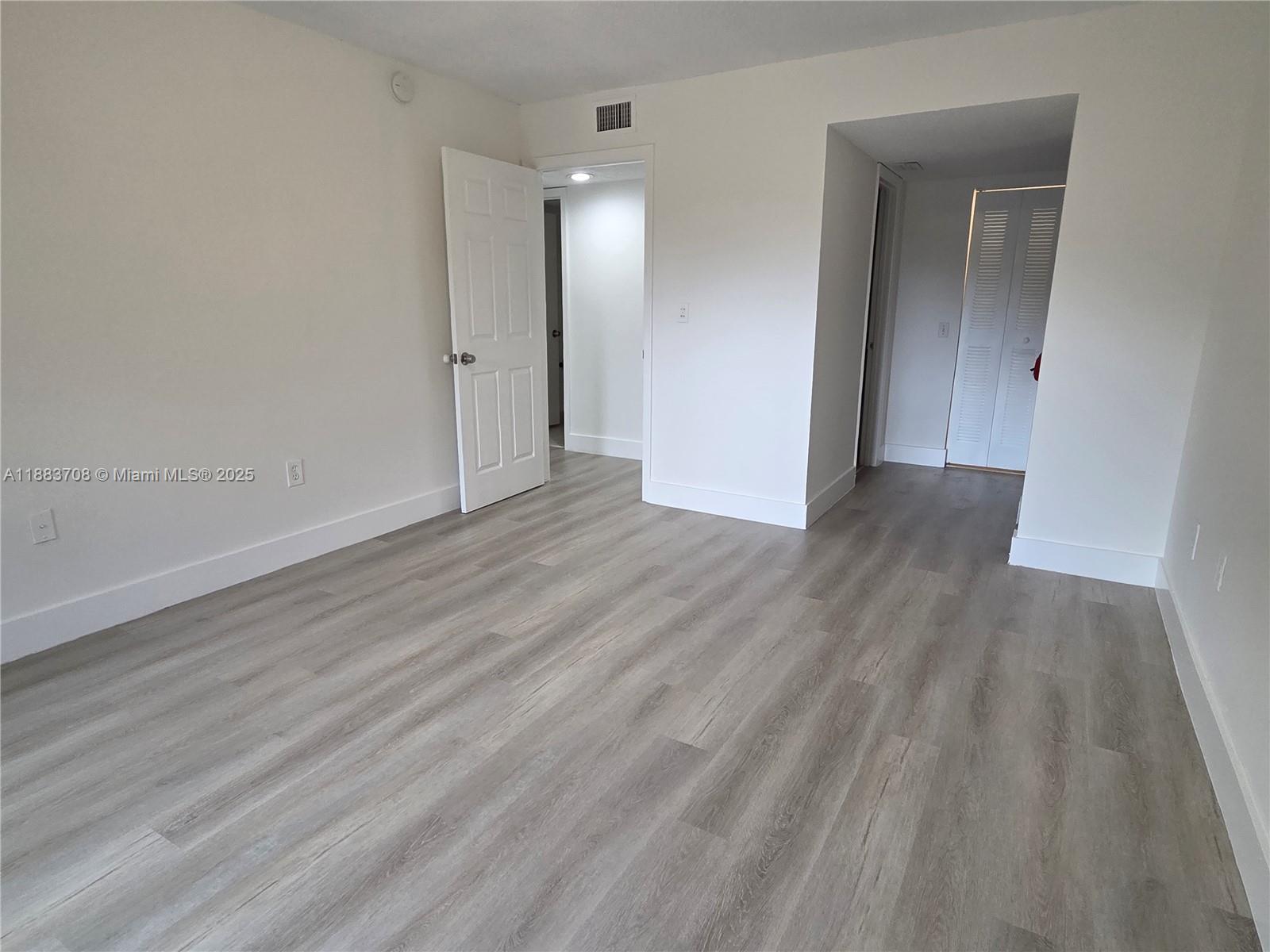 8888 Southwest 131st Court, Unit 308 Miami, FL 33186 - Photo 19 of 25 wooden floor in an empty room
