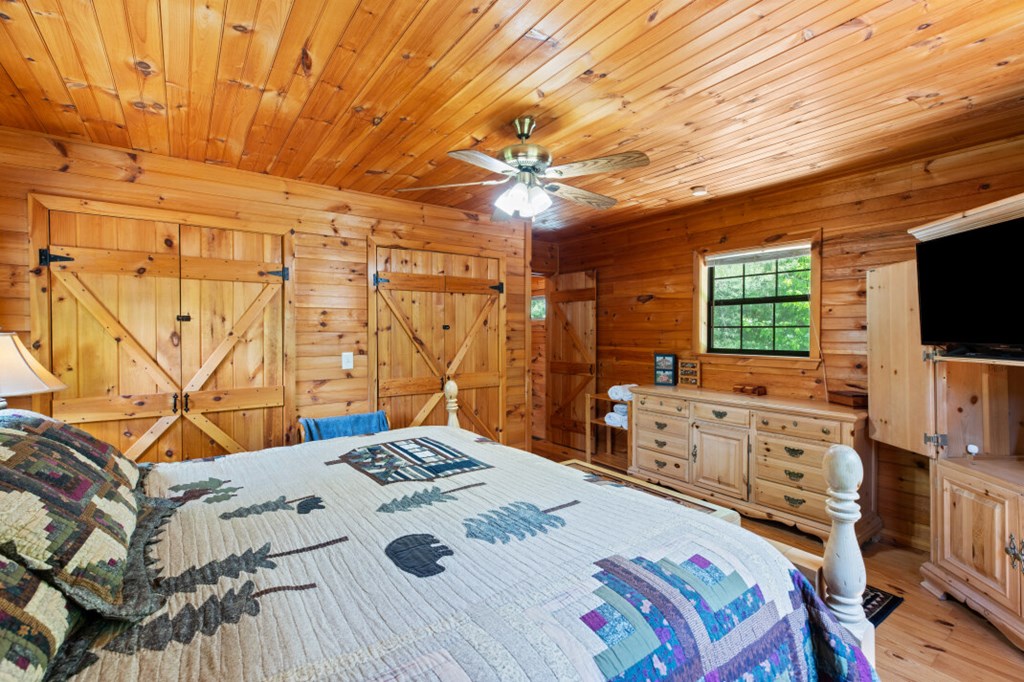 66 Fortenberry Road Young Harris, GA 30582 - Photo 24 of 55 a bedroom with a bed and a flat screen tv