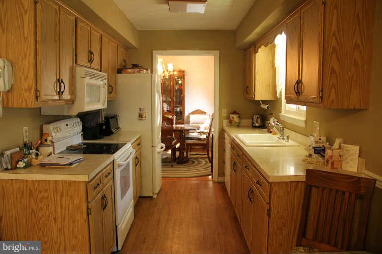 11235 Country Road Dunkirk, MD 20754 - Photo 7 of 8 a kitchen with a sink stove and cabinets